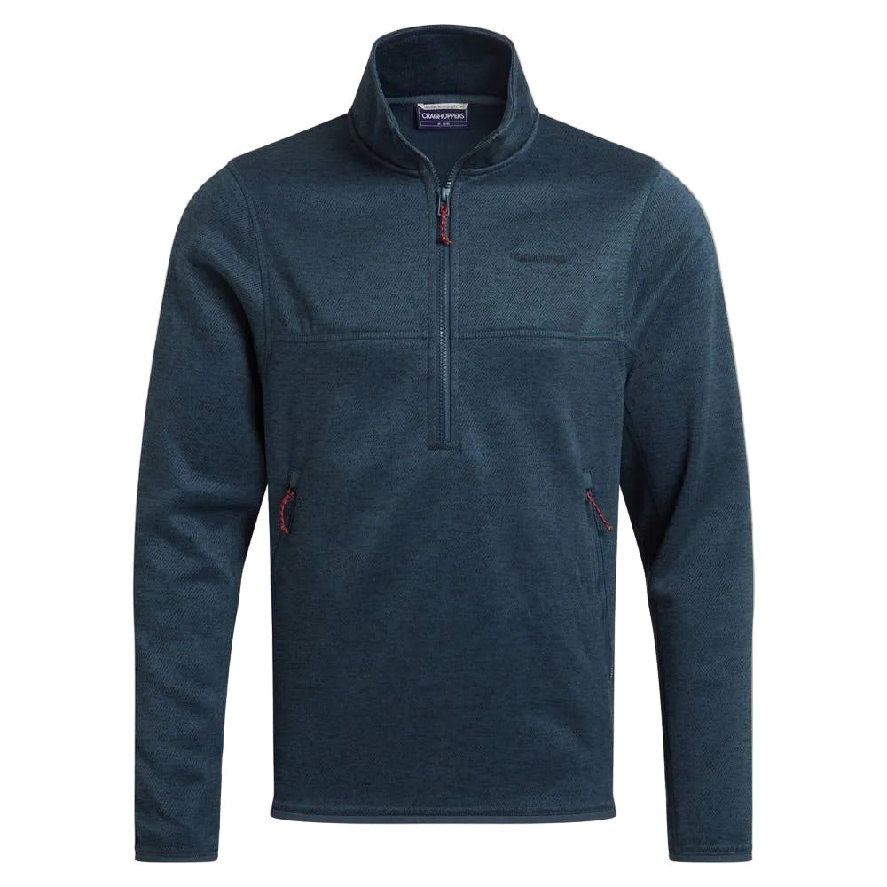 A dark blue heathered quarter-zip fleece pullover by Patagonia, featuring a stand-up collar, zippered chest pocket, and zippered hand pockets with red zipper pulls, shown against a solid beige background.