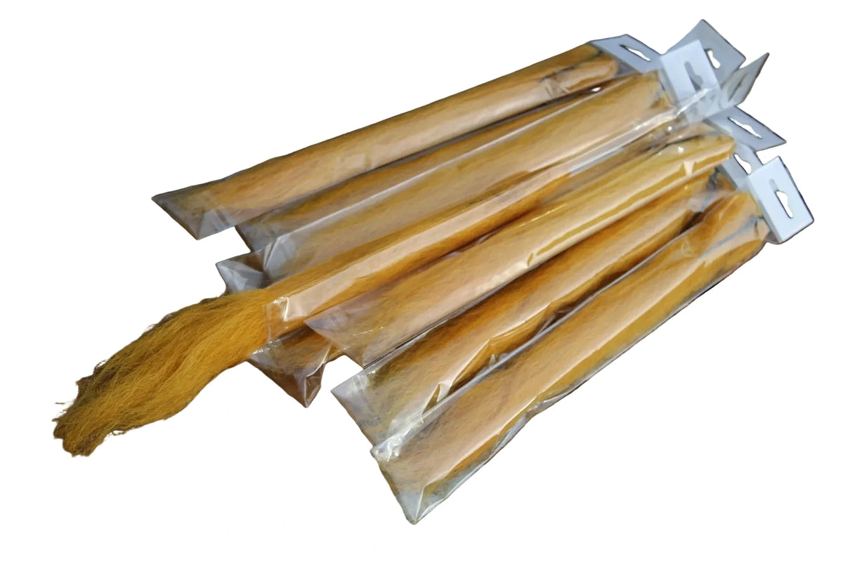 Four packaged YAKETY YAK hair extensions with long golden-brown strands, 