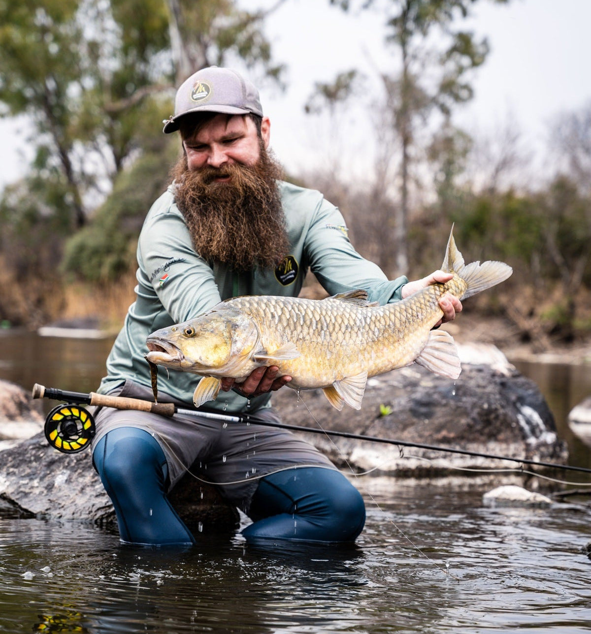 Man holding a yellowfish caught while fishing on the Vaal River