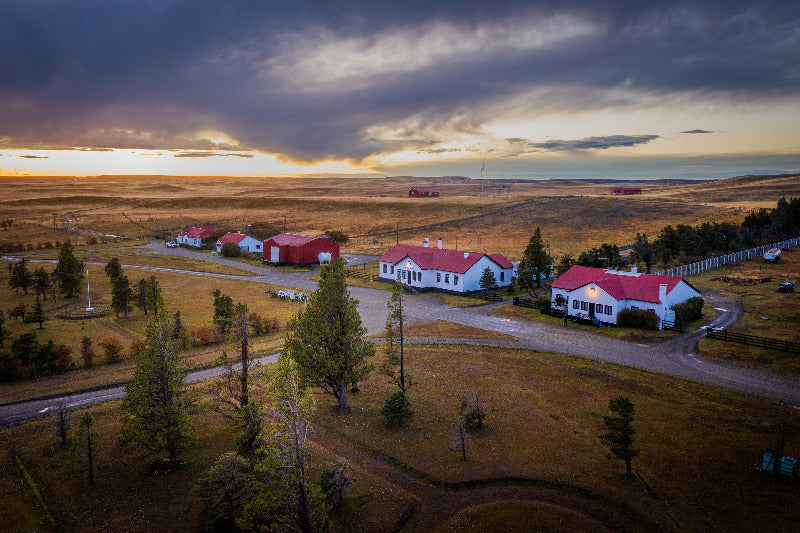Villa Maria Lodge, Rio Grande set against a dramatic sky with dark clouds and a setting sun.